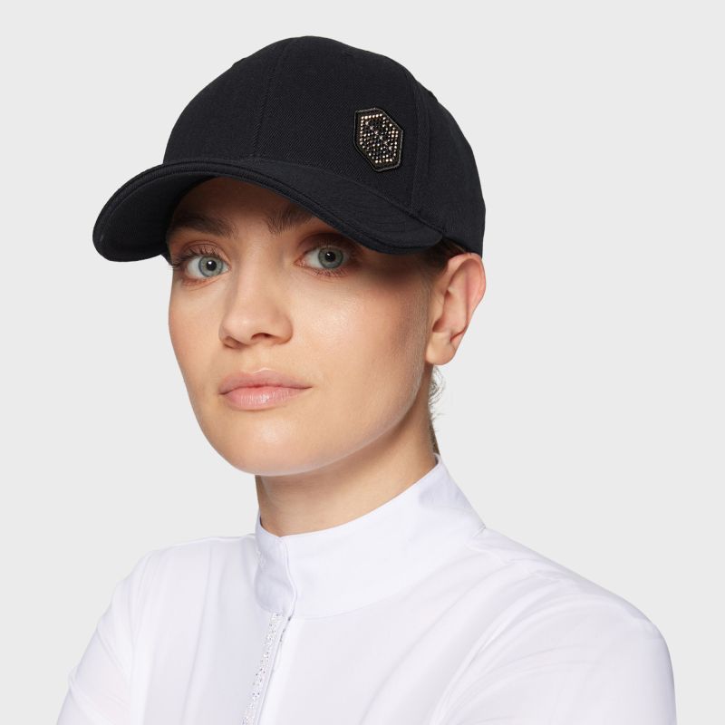 Angled front view of a female model wearing the black Samshield Sadie Pearl Metal Eclipse Cap on a plain background