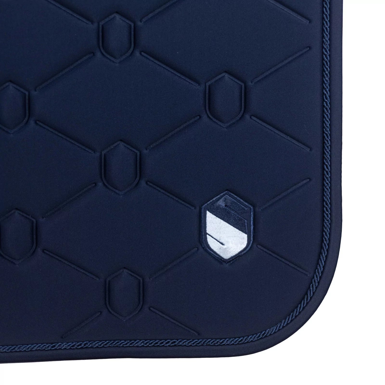 Close-up side view of the navy embroidered Samshield Spineshield Jump Pad on a white background