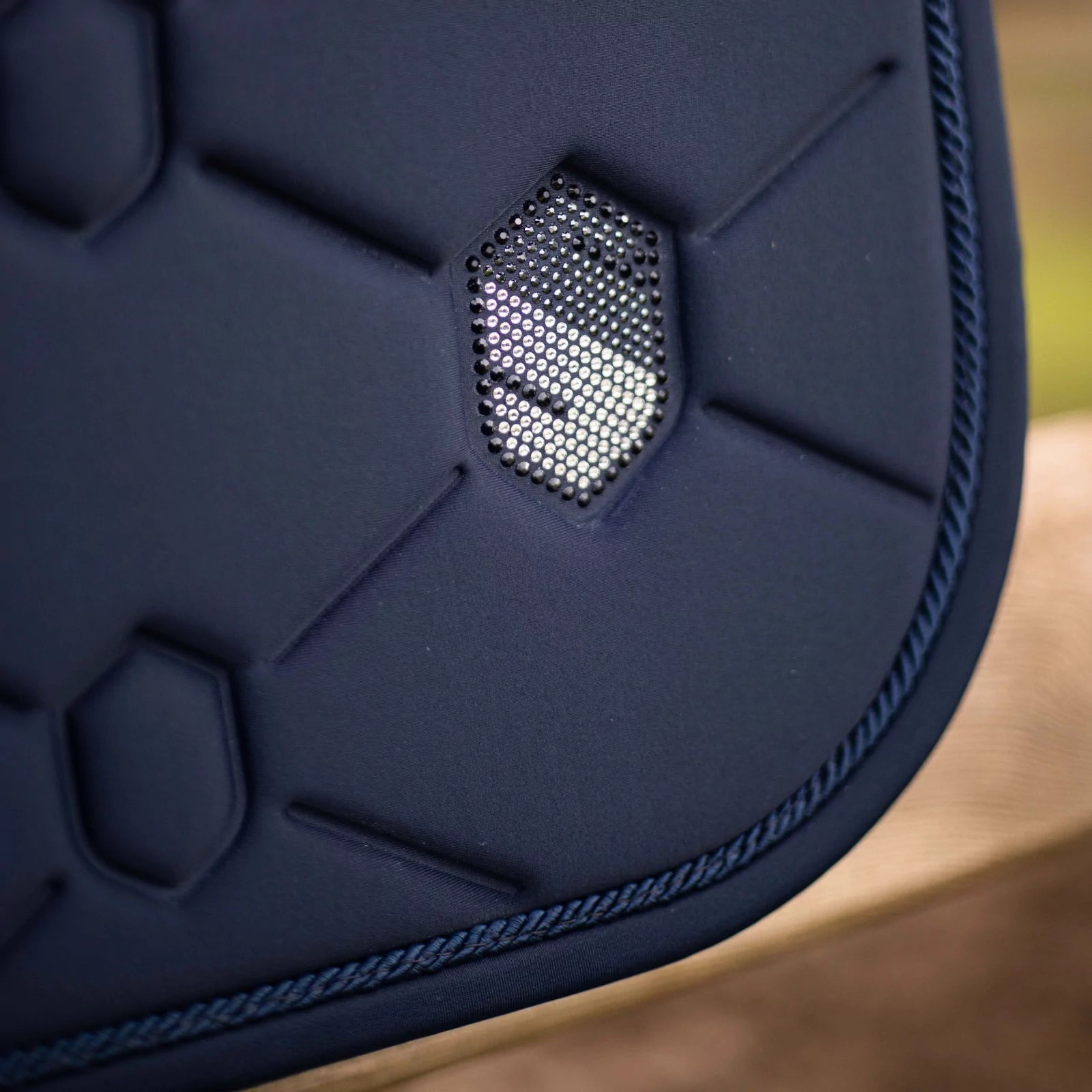 Close-up side view of the navy swarovski embroidered Samshield Spineshield Jump Pad