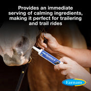 Close up view of a woman giving a tube of Farnam Quitex II Calming Paste to a horse