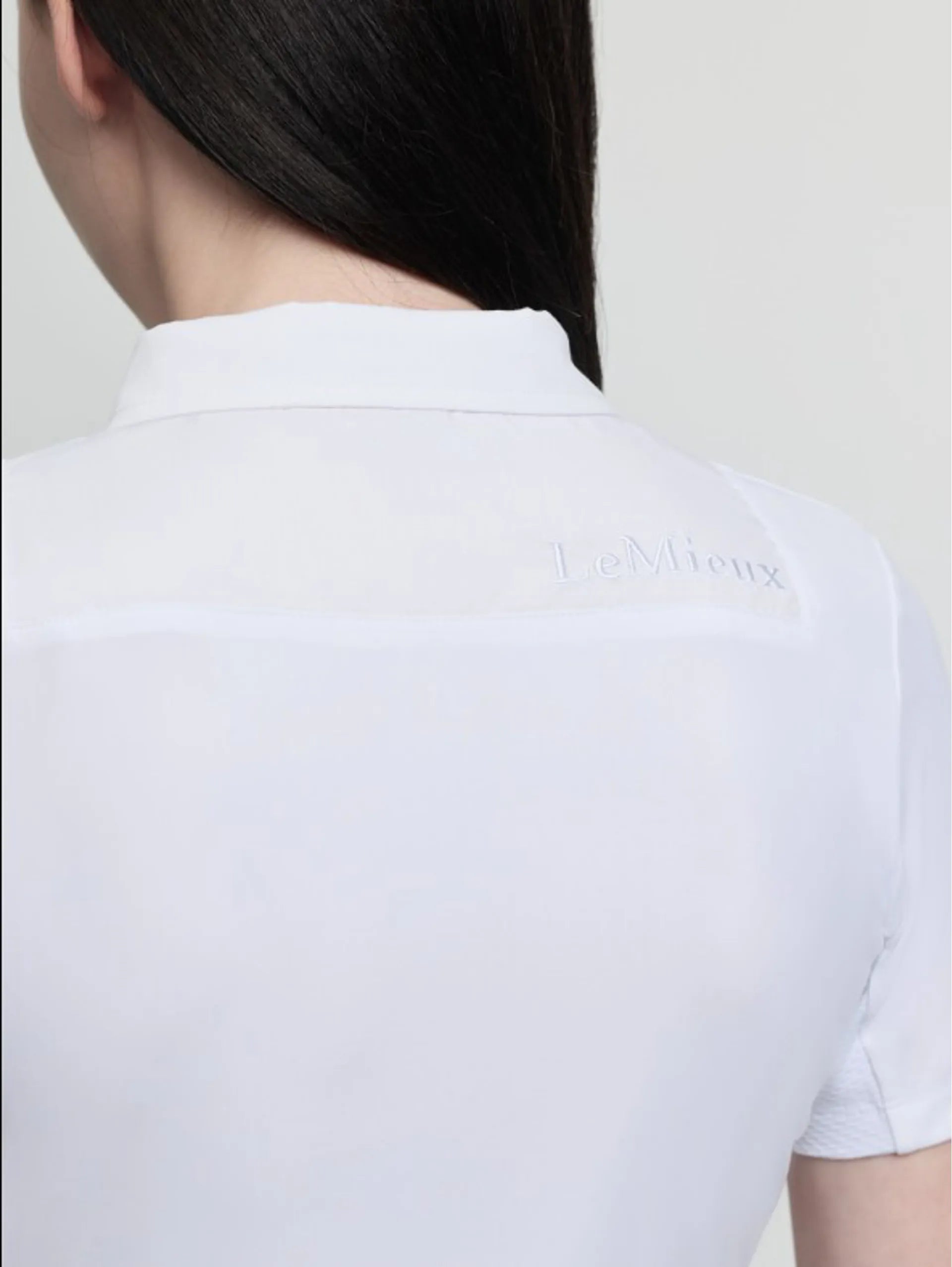 Close-up of LeMieux Junior Short Sleeve Primrose Show Shirt in white showing back collar and upper back panel