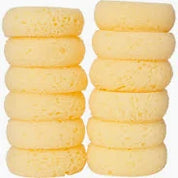 View of 12 round yellow tack sponges stacked in 2 columns on a white background