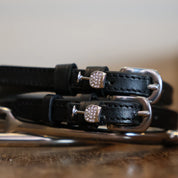 Front view of the Silver Wine GlassMane Jane Spur Straps on wood