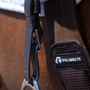 Close-up view of the adjustable buckle on the brown Total Saddle Fit Slim Stability Stirrup Leather and also a Total Saddle Fit girth, worn by a horse