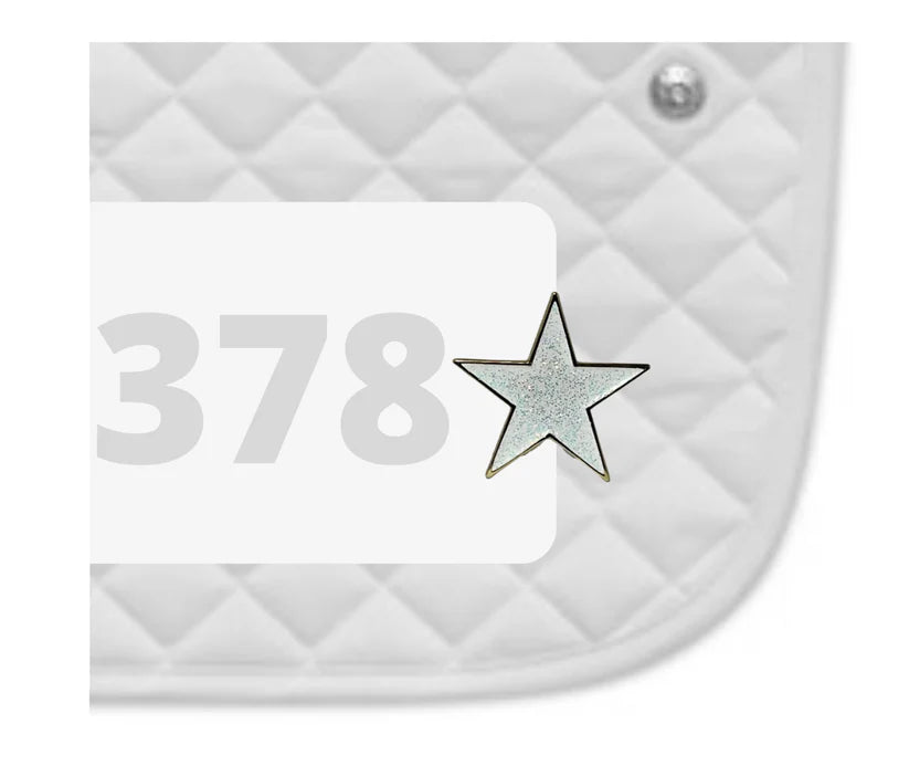 Side view of a white pad with numbers 378 and a Shining Star Dubois Cheval Number Pin Charm on a white background