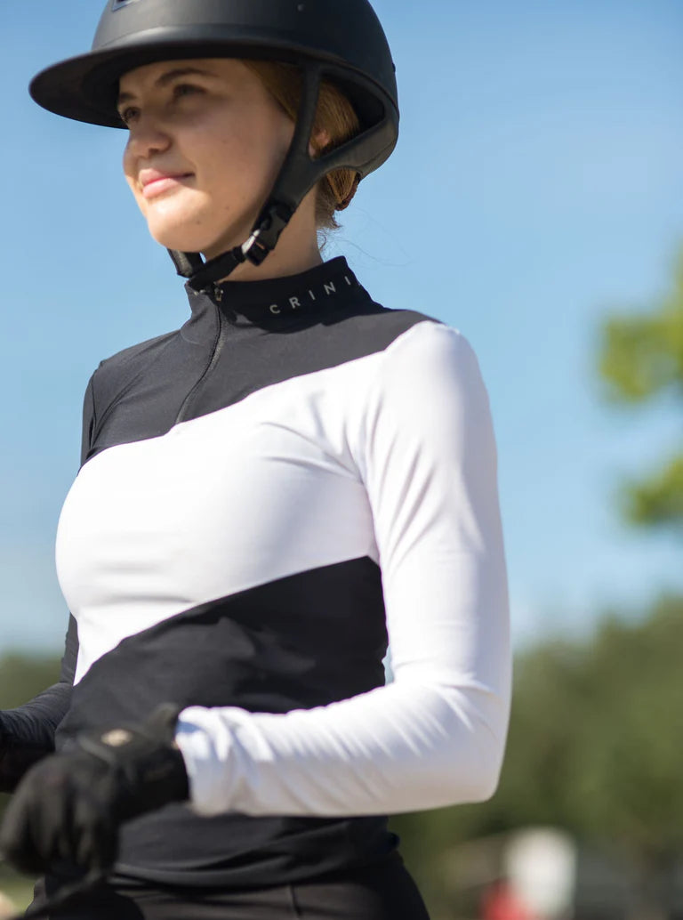 Angled front view of a model wearing the black and white Criniere Sophie Stride & Conquer Schooling Shirt