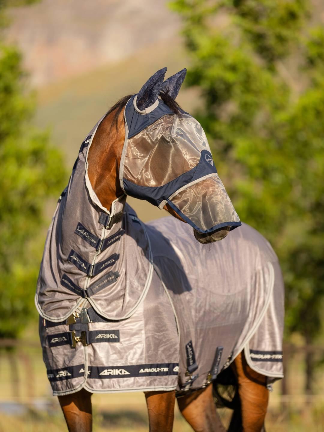 Side view of a horse wearing the navy Lemieux ArmourShield Pro Full Fly Mask outside