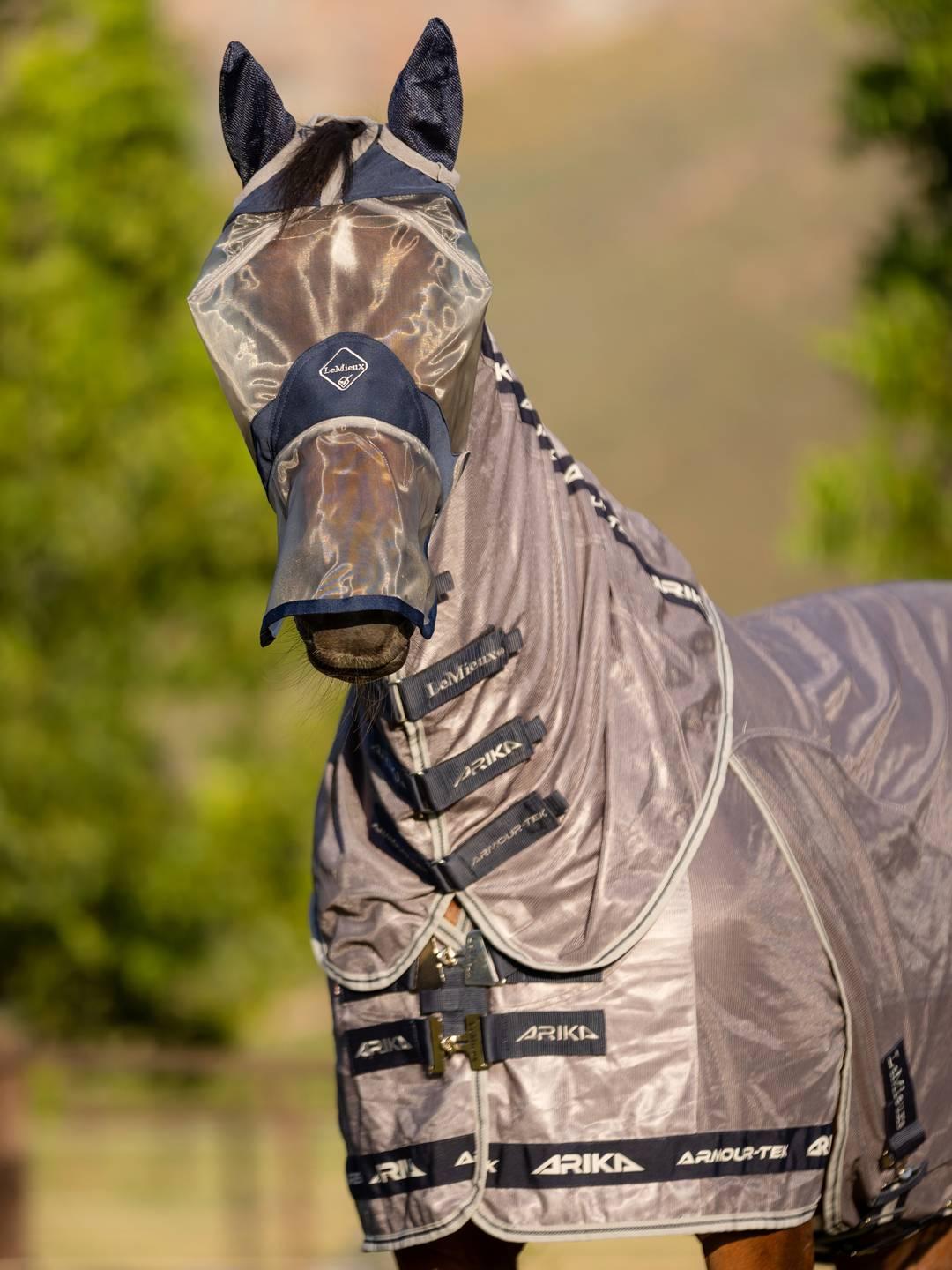 Front view of a horse wearing the navy Lemieux ArmourShield Pro Full Fly Mask outside