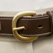 Close-up view of the buckle on the brown Equinavia Filippa Fancy Stitch Bit Belt over tan breeches