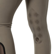 Close-up side view of a model wearing the sage olive Equinavia Maud Knee Patch Breeches on a white background