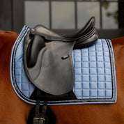 Side closeup view of a horse wearing Dusk Blue Equinavia Copenhagen Stay Put Dressage Saddle Pad