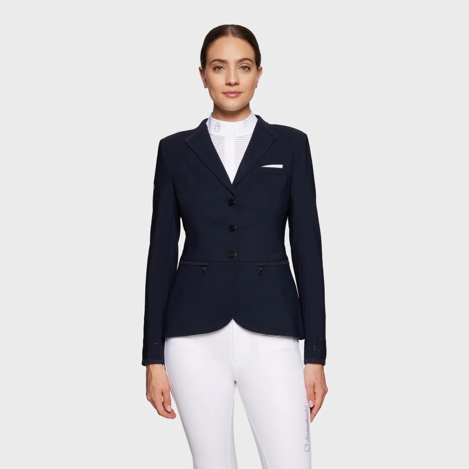 Front view of a female model wearing the navy Samshield Victorine Show Coat on a white background