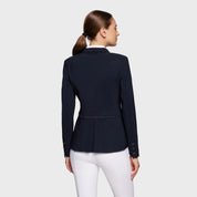 Back view of a female model wearing the navy Samshield Victorine Show Coat on a white background