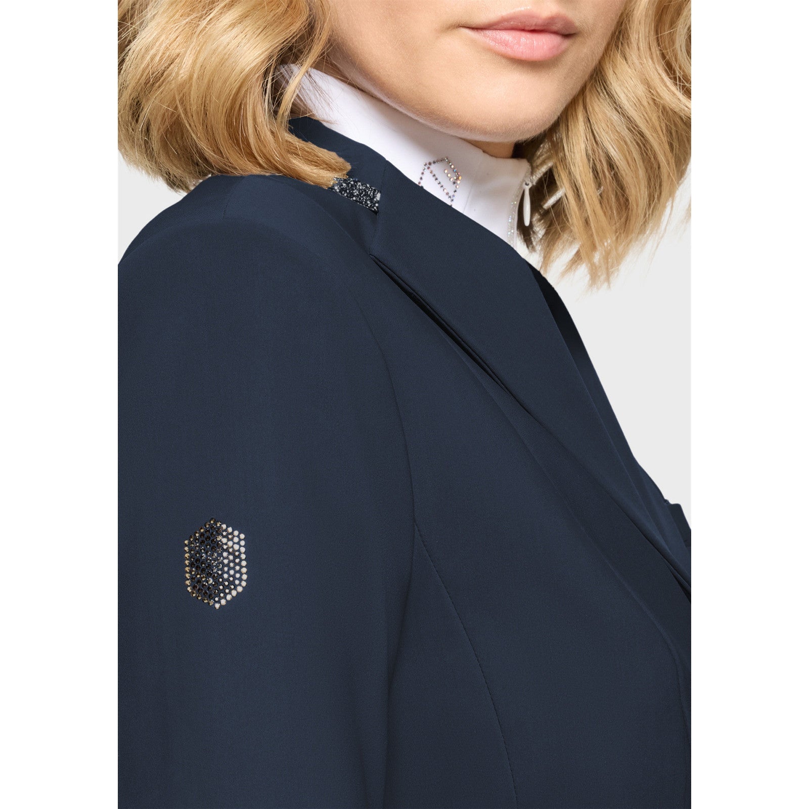 Close-up side view of a female model wearing the Navy Samshield Victory Premium Show Jacket on a plain background