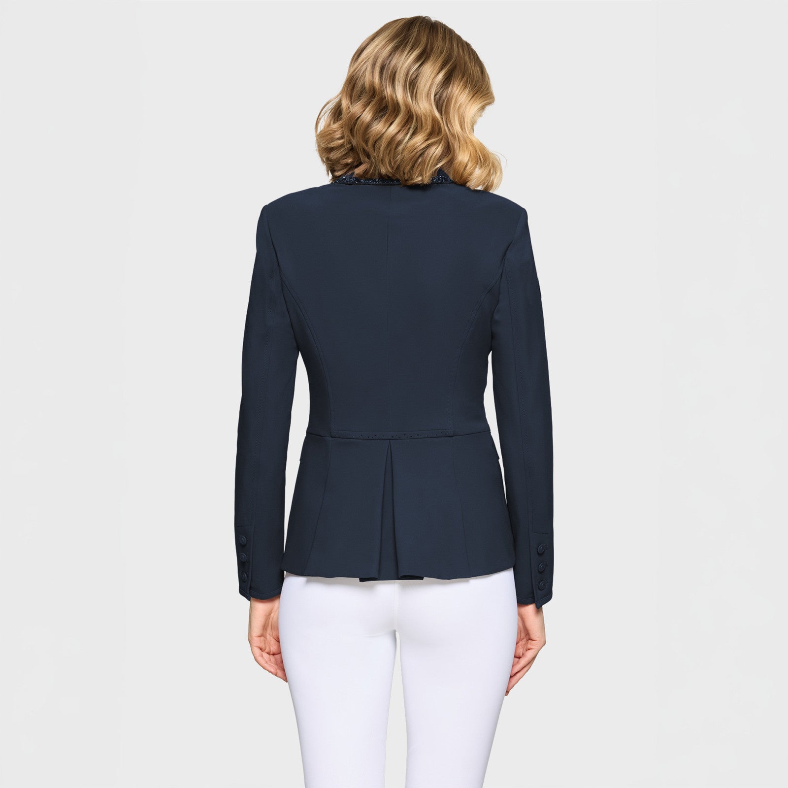 Back view of a female model wearing the Navy Samshield Victory Premium Show Jacket on a plain background