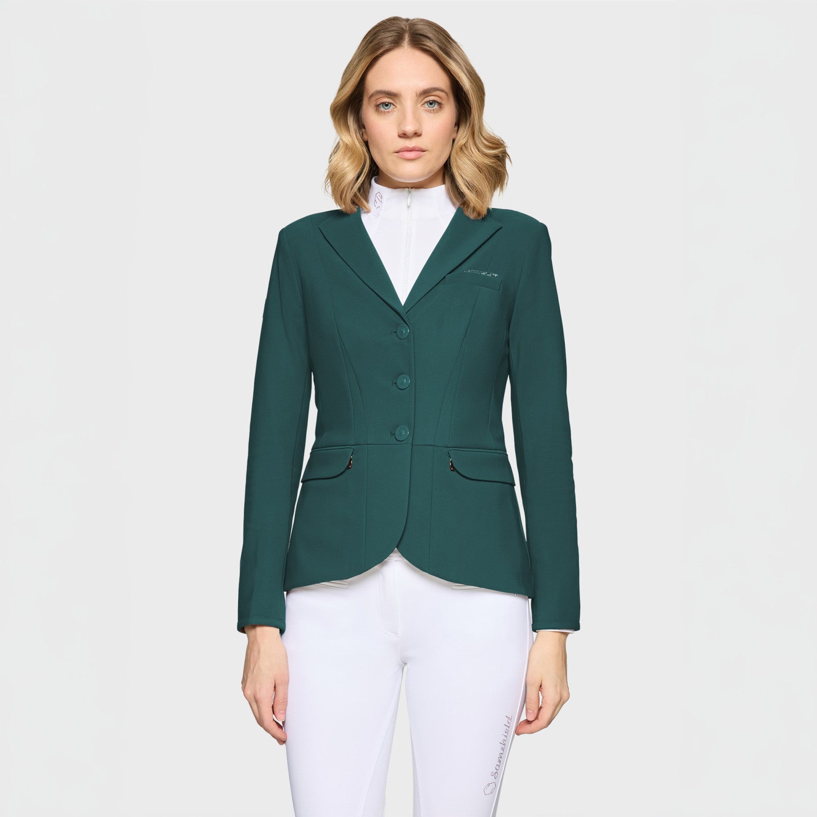 Front view of a female model wearing the hunter green Samshield Victory Premium Show Jacket on a plain background