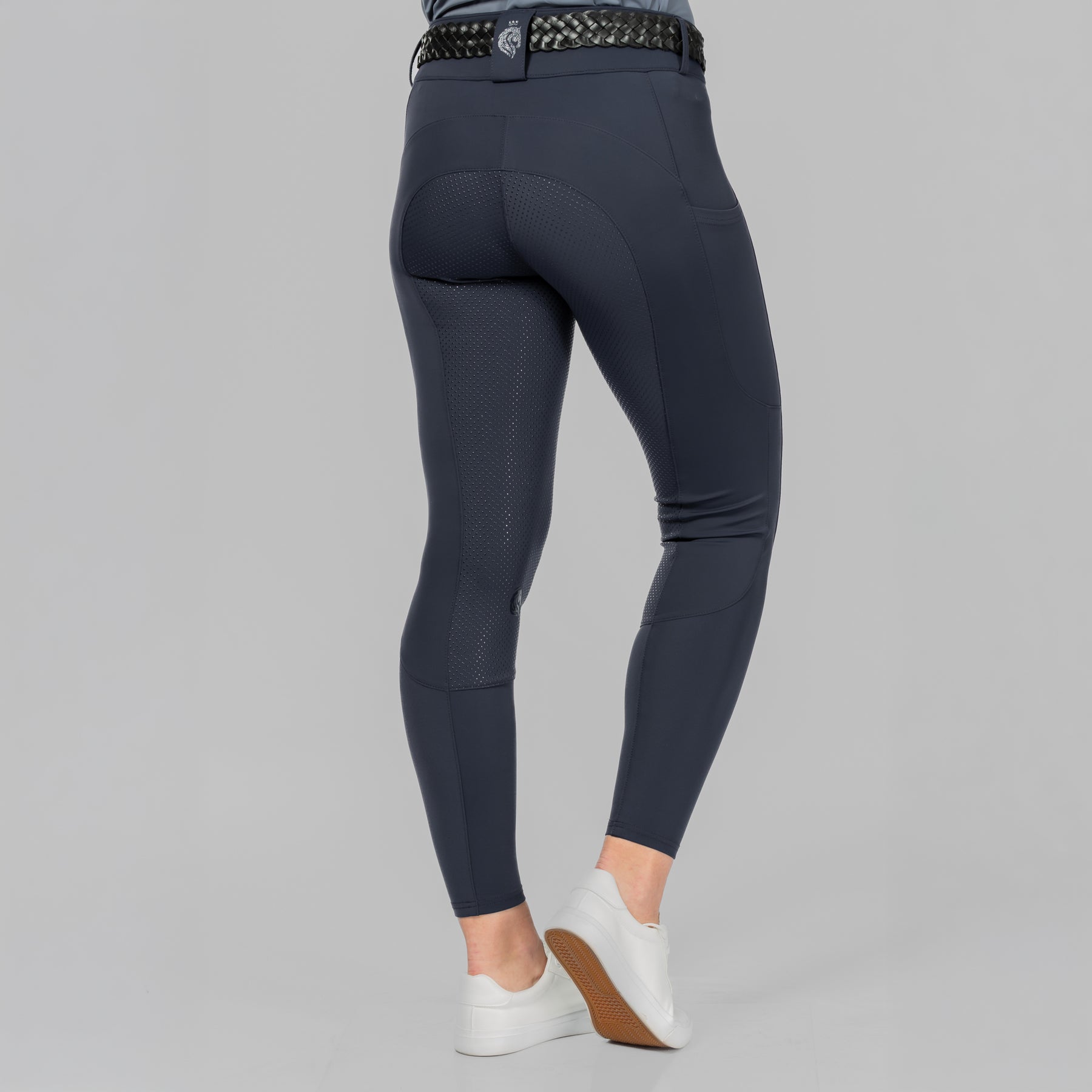 Back view of a model wearing Navy Equinavia Birgit Summer Full Seat Breeches on a plain background