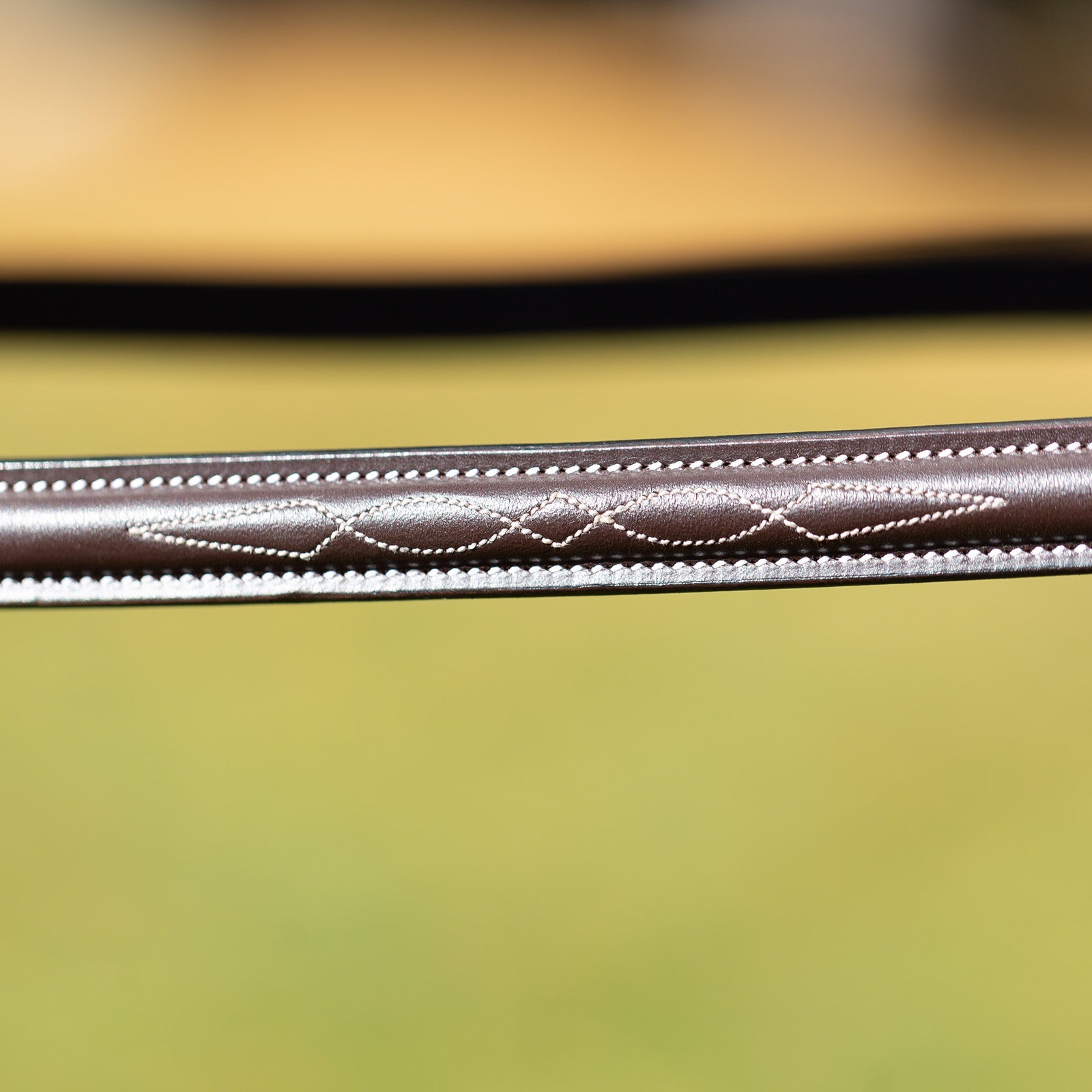 Close-up view of the browband on the brown Equinavia Valkyrie Wide Noseband Hunter Bridle with Laced Reins
