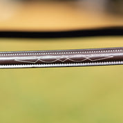 Close-up view of the browband on the brown Equinavia Valkyrie Wide Noseband Hunter Bridle with Laced Reins