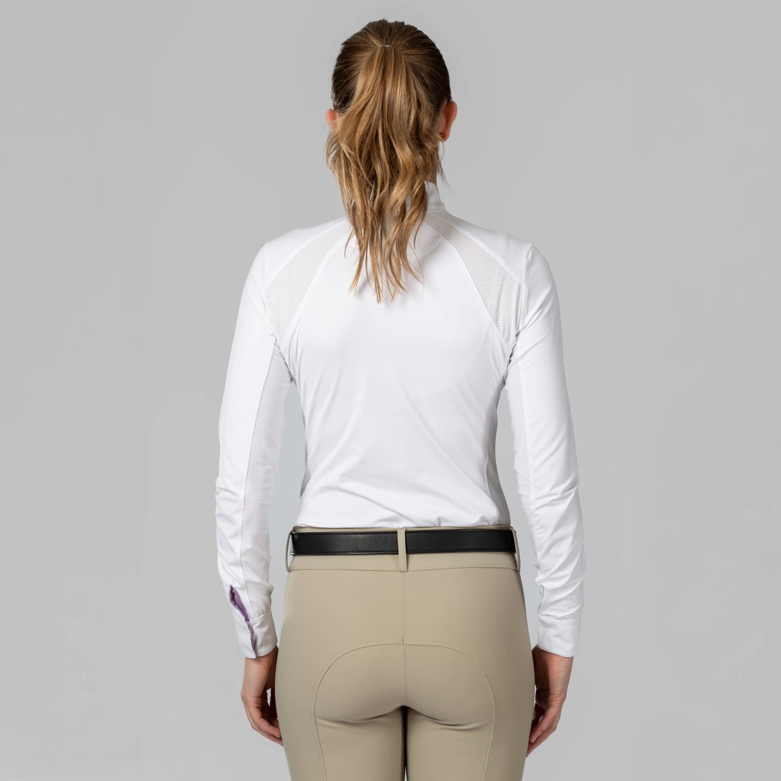 Back view of a female model wearing the Equinavia Sonja Long Sleeve Show Shirt on a plain background