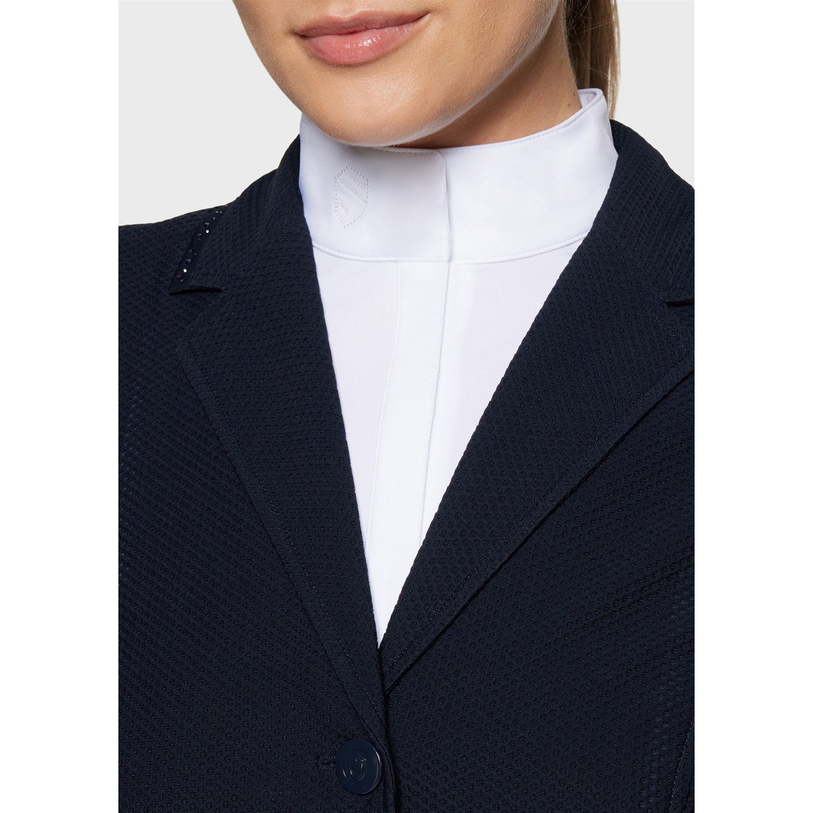 Close-up front view of a female model wearing the Navy Samshield Wellington Crystal Show Coat on a plain background