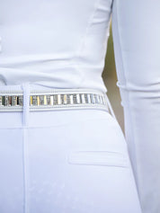Close-up back view of a model wearing the white Equestrian Stockholm Contest Belt with white breeches
