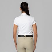 Back view of a female model wearing the white Horze Mina Short Sleeve Crystal Show Shirt on a plain background