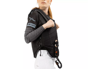 Side view of a female model wearing the Freejump X'Air Safe Airbag on a white background
