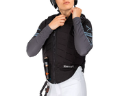 Front view of a female model wearing the Freejump X'Air Safe Airbag on a white background