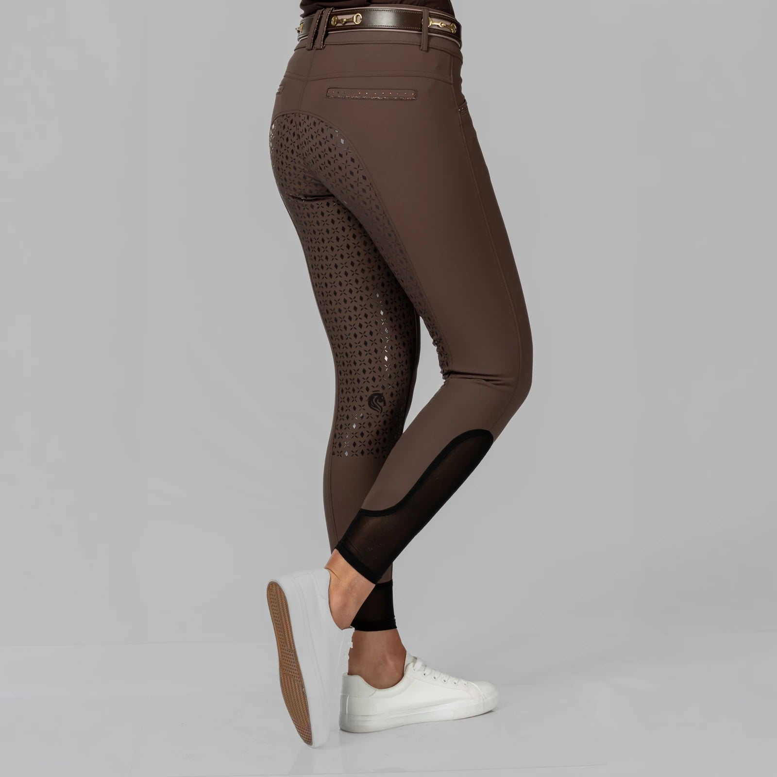 Side view of a model wearing the brown Equinavia Victoria Full Seat Breeches on a plain background