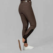 Side view of a model wearing the brown Equinavia Victoria Full Seat Breeches on a plain background