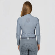 Back view of a model wearing Dusk Blue Equinavia Aurora Long Sleeve Training Shirt on a plain background
