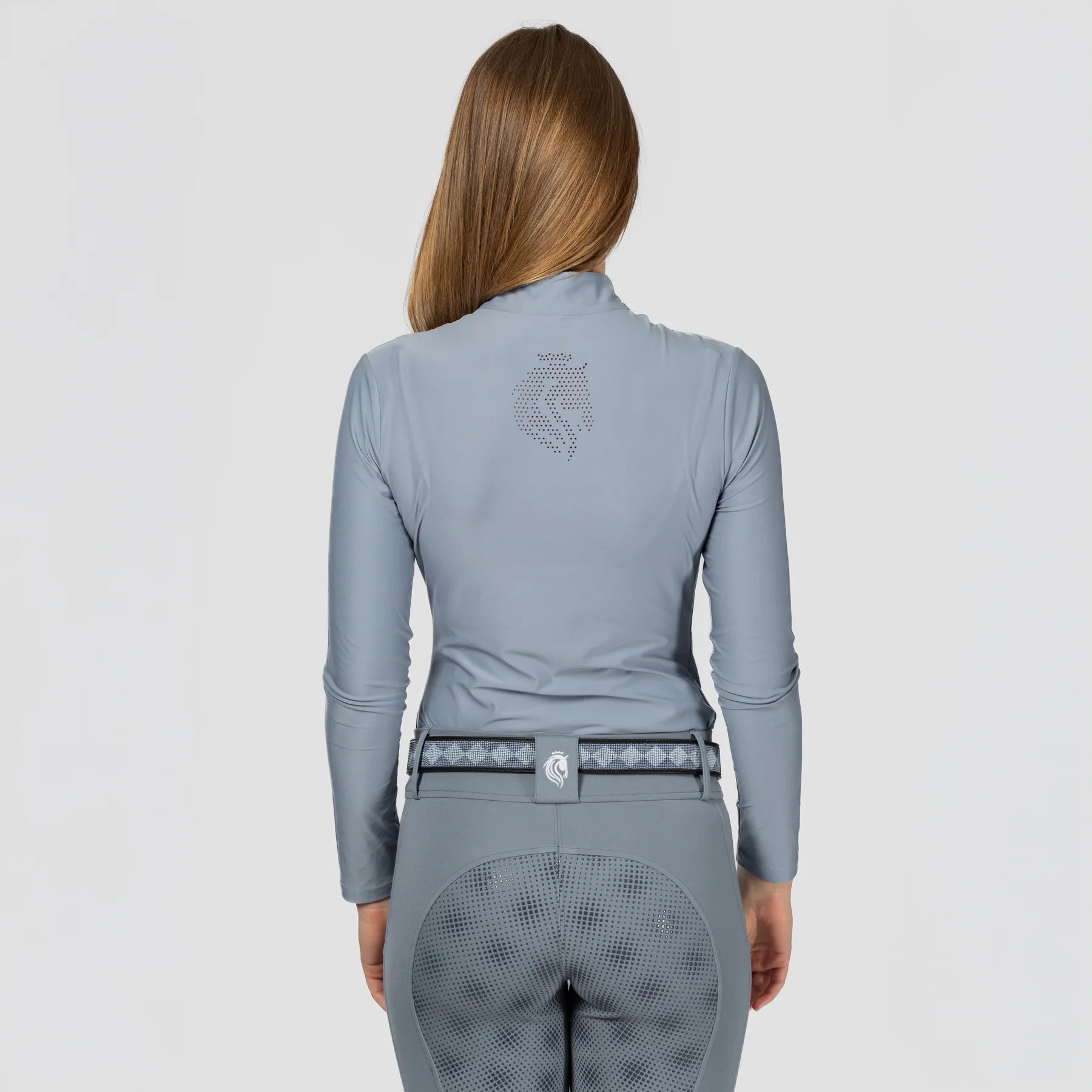 Back view of a model wearing Dusk Blue Equinavia Aurora Long Sleeve Training Shirt on a plain background