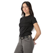 Angled front view of a model wearing a black top, gray breeches, and the beige and gray, black-leather Equinavia Siri Polo Belt on a white background