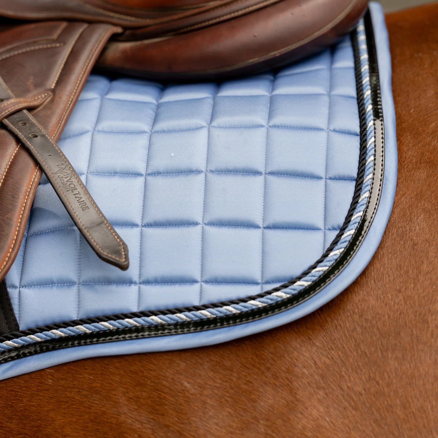 Side closeup view of a horse wearing Dusk Blue Equinavia Copenhagen Stay Put All Purpose Saddle Pad