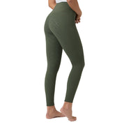 Side view of a female model wearing the Beetle Khaki Green Horze Gillian Silicone Full Seat Tights on a white background