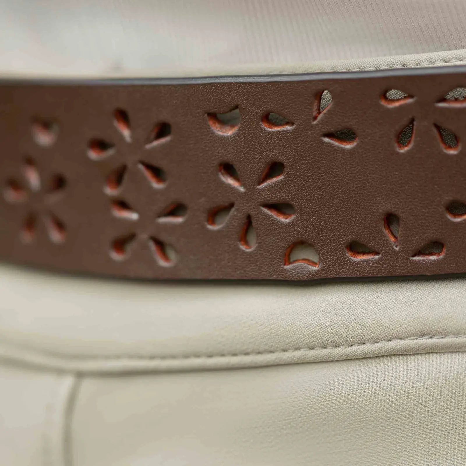 Close up view of the Equinavia Emmi Flowers Leather Belt worn over a pair of breeches