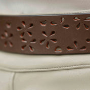 Close up view of the Equinavia Emmi Flowers Leather Belt worn over a pair of breeches
