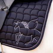 Close-up view of the black Horze Pegasus Pony Saddle Pad on a white horse